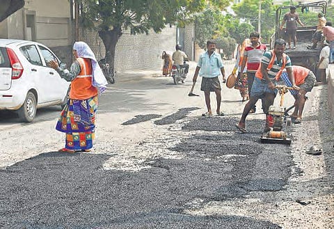 File photo of GHMC workers filling potholes on Road No. 10, Jubliee Hills