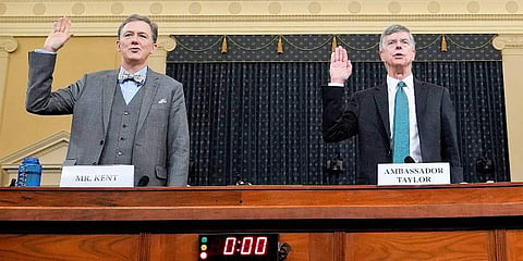 Career Foreign Service officer George Kent and top U.S. diplomat in Ukraine William Taylor, right, are sworn in to testify during the first public impeachment hearing of the House Intelligence Committee on Capitol Hill, Wednesday Nov. 13, 2019, in Washing