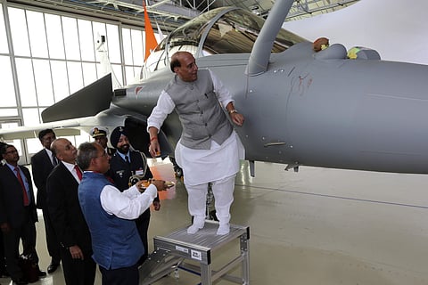 Union Defence Minister Rajnath Singh has a ritual gesture onto a Rafale jet fighter during the handover cermony at the Dassault Aviation plant. (Photo | AP)