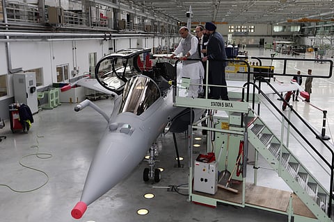 Union Defence Minister Rajnath Singh stands by a Rafale jet fighter in Merignac in southwestern France. Singh formally accepted the first Rafale fighter jet after India had signed a deal with the French government and Dassault Aviation in September 2016,