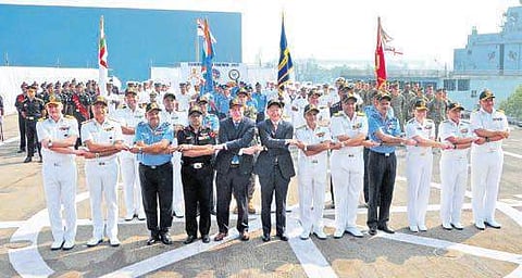 Indian and US armed forces members holding hands during parade onboard INS Jalswa at the inaugural of Tiger Triumph in Visakhapatnam on Thursday. (Photo | EPS)