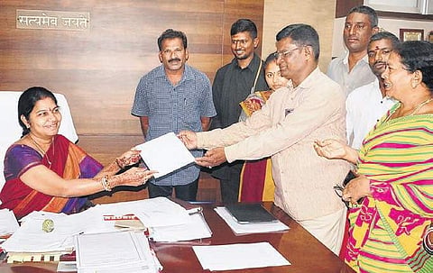 The temple committee members submitting representation mentioning willingness for demolition of temple to GMC commissioner C Anuradha| Express