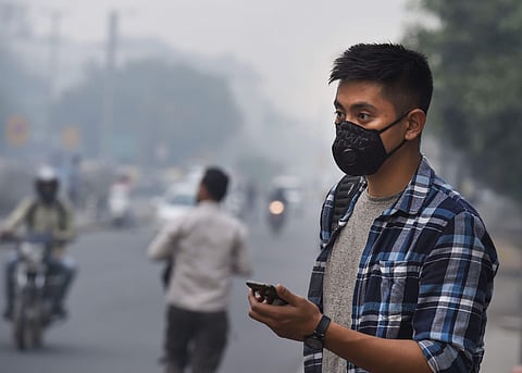 A tourist wears an anti-pollution mask amid heavy smog. (File | PTI)