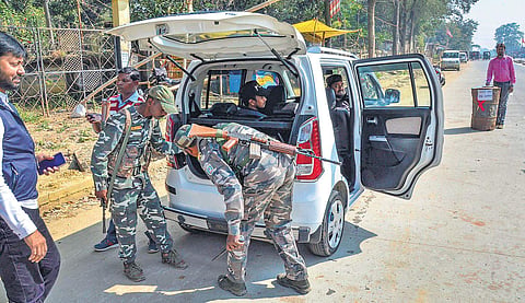 Security forces check a four-wheeler ahead of the first phase of Jharkhand Assembly Election, at NH 75 on Saturday. (Photo | PTI)