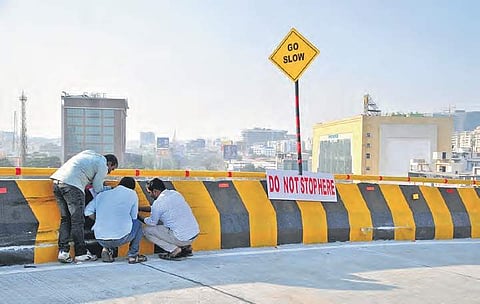 Officials examining the spot from where the speeding car climbed the Biodiveristy flyover's railing and fell on the road below on Saturday.