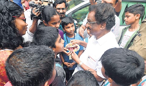 Minister for Culture A K Balan gets a whiff of spices during the Kerala Piravi celebrations, organised by Malayalam Pallikoodam at Model LP School, Thycaud, on Sunday | Express