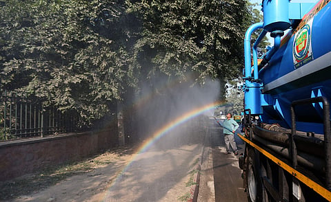 YSDMC worker spray water on the tree in New Delhi on Tuesday. | (Photo | Arun Kumar, EPS)
