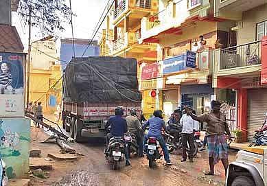 The truck pulled dangling power cables along with it, causing a commotion, in Bengaluru on Tuesday | Express