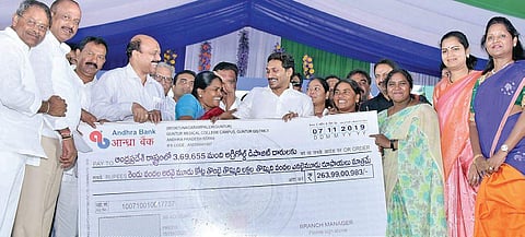 YS Jagan Mohan Reddy hands over the cheque to AgriGold depositors at Police Parade Grounds in Guntur on Thursday. (Photo | EPS)