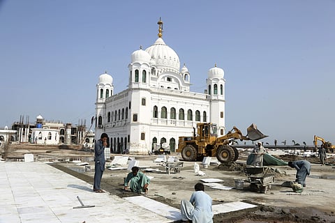 Workers give finishing touches to the shrine of Sikh spiritual leader Guru Nanak Dev, in Kartarpur. (File Photo | AP)