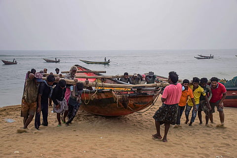 Fishermen pull their boats to away from the sea following Cyclone Bulbul warning in Puri. | (File Photo | PTI)