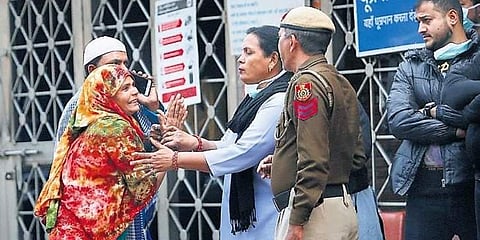 A woman pleads to a security woman to allow her enter the emergency ward of LNJP hospital in New Delhi on Sunday. (Photo | Arun Kumar, EPS)