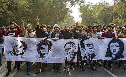 JNU students raise slogans as they take part in a march from the University campus to Rashtrapati Bhavan to 'save public education.' (Photo | PTI)