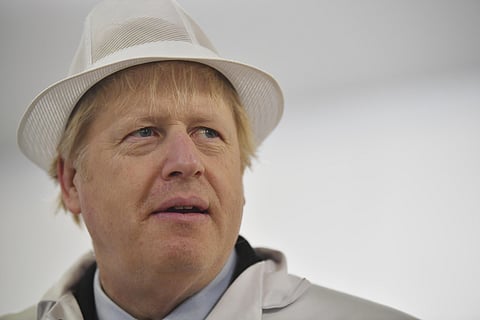 Britain's Prime Minister and Conservative Party leader Boris Johnson, center, visits Grimsby fish market in Grimsby, northeast England, Monday December 9, 2019, ahead of the general election on December 12 | AP