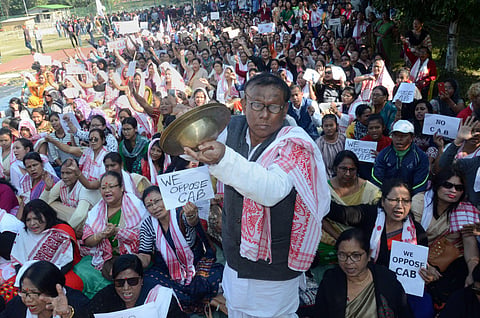 A man plays cymbals as protestors gather during an agiatation against the passing of Citizenship Amendment Bill in Dibrugarh Saturday Dec. 14 2019. (Photo | PTI)