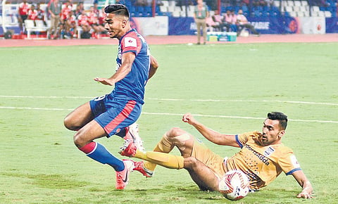 Bengaluru FC’s Ashique Kuruniyan (left) and Sarthak Golui of Mumbai City FC vie for the ball during their ISL clash in Bengaluru on Sunday | shriram bn