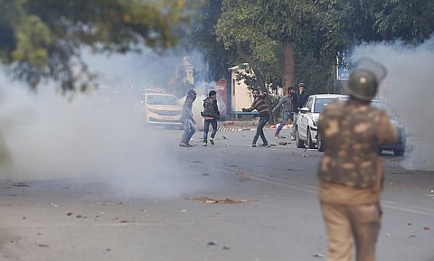 Police chase away demonstrators during a protest against a new citizenship law in New Delhi on Sunday. (Photo | Arun Kumar P/EPS)