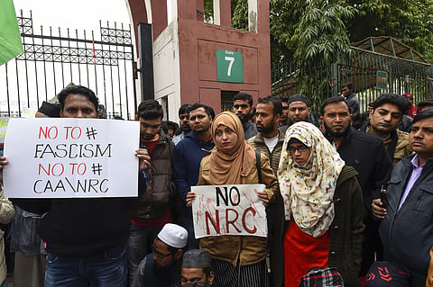 Students along with general public hold placards during a protest against the Citizenship Amendment Act CAA outside Jamia Millia Islamia University in New Delhi Tuesday Dec. 17 2019. (Photo | PTI)