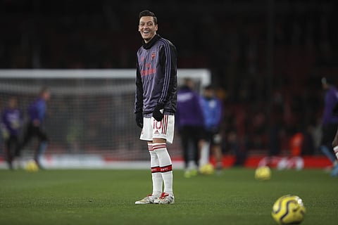 Arsenal's Mesut Ozil smiles during warm up. (Photo | AP)