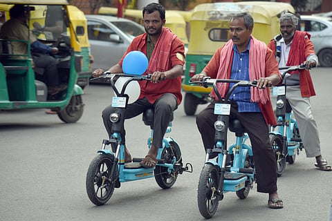 Porters are seen using the battery-powered bikes during the inauguration at Cantonment Railwaystation in Bengaluru on Friday. (Photo | Nagaraja Gadekal P)
