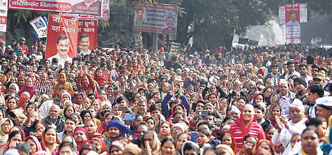 AAP supporters and locals gather at the Delhi government’s programme to distribute survey certificates to the people living in slums