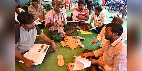 Villagers composing letters to Prime Minster Narendra Modi, seeking his intervention, as part of the protest at Velagapudi.
