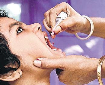 A child taking polio medication.