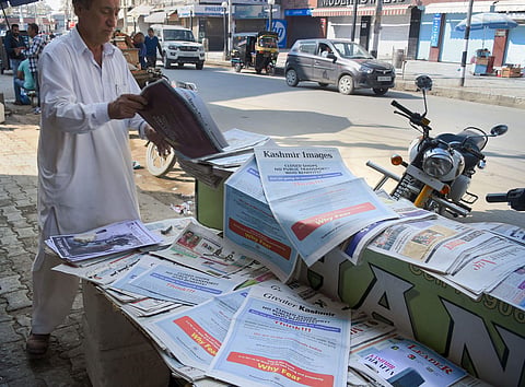 A man buys newspaper at a stall in Srinagar. (File Photo | PTI)