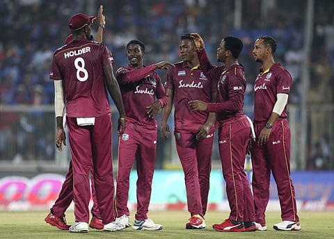 West Indies' Hayden Walsh, second left, celebrates with teammates the dismissal of India's Shivam Dube. (Photo | AP)
