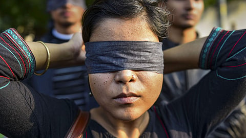 Women blindfold during a protest to highlight the issue of violence against women in the country in New Delhi.
