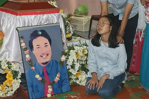 One of Reena's sister's next to a portrait of her father (Photo | EdexLive)
