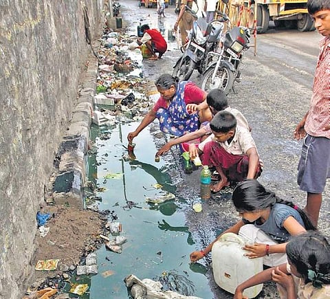 Residents collect oil that is leaking to the surface at Kasimedu | Express
