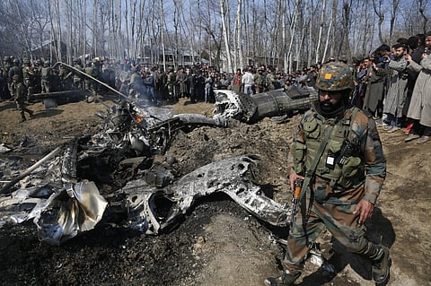 An Indian army solider walks past the wreckage of an Indian aircraft after it crashed in Budgam area, outskirts of Srinagar, Kashmir on Wednesday, Feb.27, 2019. (Photo | AP)