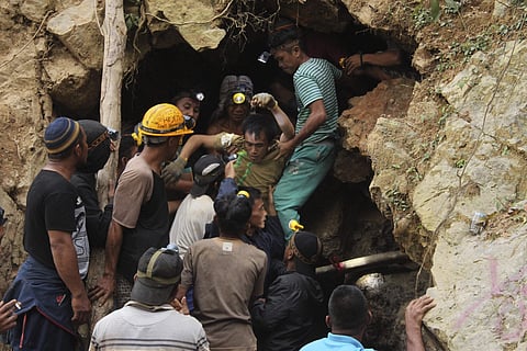 FILE- Rescuers carry a survivor from inside a collapsed mine in Bolaang Mongondow, North Sulawesi, Indonesia.
