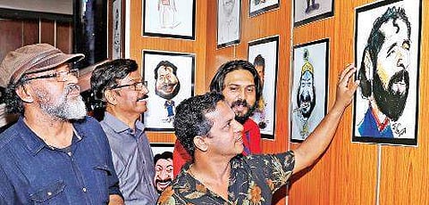 Dharmajan Bolgatty viewing the caricatures along with the organisers of the show at Saritha Theatre on Friday Arun Angela
