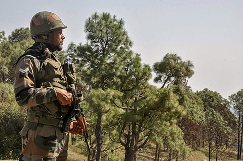 Security personnel stand guard during a search operation after Army troops foiled a infiltration bid from across the Line of Control (LoC) in Jammu.
