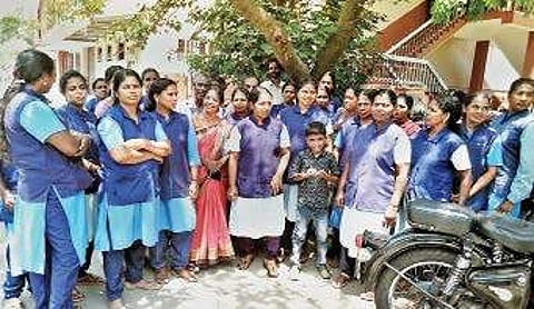 Women employees who are on a protest seeking pending salary Express
