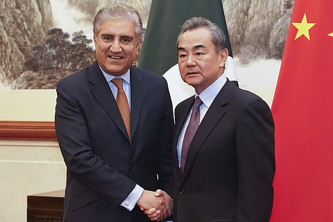 Pakistani Foreign Minister Shah Mahmood Qureshi, left, and Chinese Foreign Minister Wang Yi shake hands at the Diaoyutai State Guesthouse in Beijing, Tuesday, March 19, 2019. (Photo | AP)
