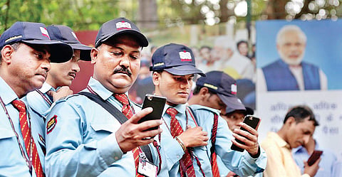 Security guards listen to PM Narendra Modi’s address as part of the ‘Main Bhi Chowkidar’ campaign in Delhi on Wednesday | Shekhar yadav