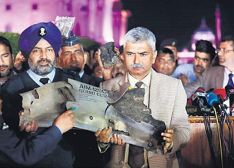 Indian Air Force officials display a piece of an AMRAAM missile, from a Pakistani Air Force F-16 jet, during a press conference at South Block in New Delhi on Thursday. (Photo | EPS/Shekhar Yadav)