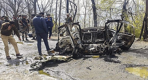 Security personnel inspect the mangled remains of a car which exploded near a CRPF convoy on the Jammu-Srinagar highway at Banihal in Ramban district of Jammu and Kashmir Saturday March 30 2019. | PTI