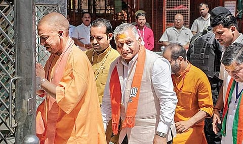 UP CM Yogi Adityanath with BJP candidate VK Singh visits a temple in Ghaziabad on Sunday | Pti