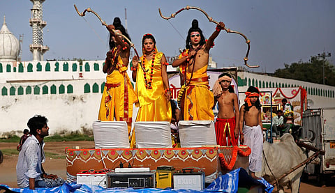 Artists dressed as Lord Rama (R) his brother Lakshman and Sita participate in a religious procession on Ram Navami in New Delhi. (Photo | AP)