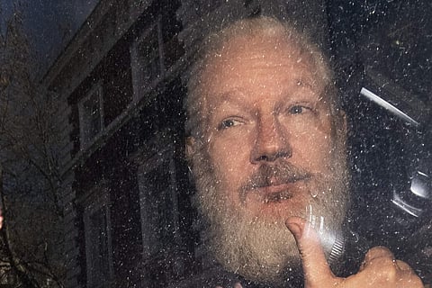 Julian Assange gestures as he arrives at Westminster Magistrates' Court in London (Photo | AP)