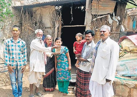 Parents and villagers with Pavitra outside their house in Chulaki village of Saundatti | Express