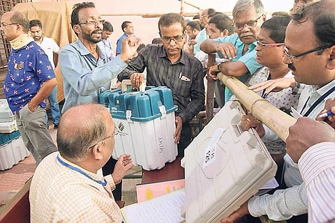 Polling officials collecting their EVMs from a distribution centre in Bhubaneswar on Sunday | Express