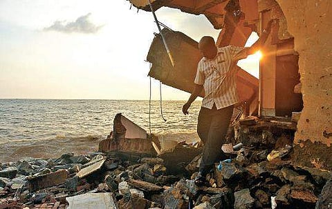 Stephen Benny searching valuables in the house after coming to know about that his house was destroyed following sea erosion at Valiathura B P Deepu
