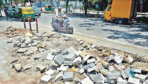 Broken tiles of a footpath near Vega City Mall in JP Nagar. Several foootpaths in the city, which are meant for pedestrians, are in bad shape. Most of them have either been encroached by shops and vendors or have uneven tiles | sHRIRAM B N