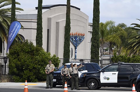 San Diego county sheriff deputies stand in front of the Chabad of Poway synagogue on Sunday (Photo | AP)