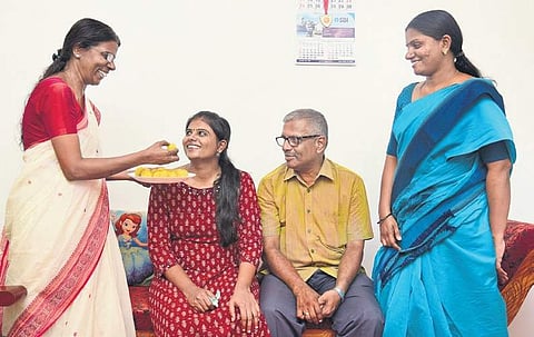 Sreelakshmi R greeted by her mother Kaladevi, father V A Ramachandran and sister Vidhya, at her residence in East Kadungalloor near Aluva on Saturday | Albin Mathew